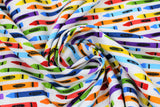 Swirled swatch Crayons fabric (white fabric with coloured crayons with colour labels allover: blue, yellow, red, orange, green, etc.)