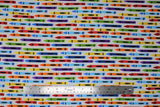 Flat swatch Crayons fabric (white fabric with coloured crayons with colour labels allover: blue, yellow, red, orange, green, etc.)