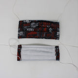 Front and back view of mask with white elastic ear loops (black fabric mask with grey chain link fence look and "Farm to Fork" text allover in white and red, tractors, and some farm animals)