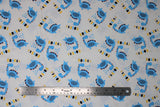 Flat swatch Dino Roarrr fabric (white fabric with tossed blue cartoon style dinosaurs with "ROARRR" text in black, yellow and blue)