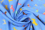 Swirled swatch assorted blue fabric (blue fabric with tossed small assorted cartoon dogs and tiny bones in yellow, blue, pink colourway with brown weiner dogs)