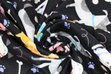 Swirled swatch dogs fabric (black fabric with tossed illustrative style colourful dogs in various breeds allover with white bones, purple paw prints and white swirls)