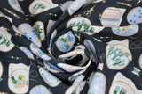 Swirled swatch embroidery hoop printed fabric (black fabric with small tossed embroidery hoop cartoon designs allover with works in progress, tossed needles, thread, scissors, floral, leafy, cactus designs)