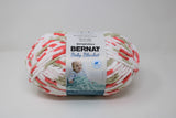 Ball of Bernat Baby Blanket in shade Flowerpot (red, white, taupe)
