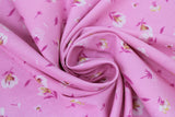 Swirled swatch lilies and dandelions pink fabric (light pink fabric with small tossed white and pink lilies and dandelions allover)