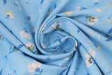 Swirled swatch lilies and dandelions blue fabric (light blue fabric with small tossed white and blue lilies and dandelions allover)