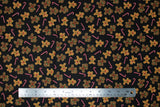 Flat swatch Tossed fabric (black fabric with tossed small brown gingerbread cookies and tossed red and white candy canes)