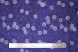 Flat swatch purple circles fabric (purple fabric with small faded black/grey circles comprised of small dots allover with tossed occasional white circles comprised of small dots)