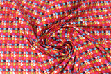 Swirled swatch hearts fabric (red fabric with lines of small hearts allover in white, black, and rainbow colours)