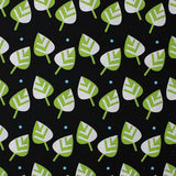Square swatch leaves fabric (black fabric with tossed green and white cartoon style leaves with blue polka dots)