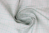Swirled swatch bee backgrounds fabric (white fabric with teal grid lines solid squares with 4 squares within separated by dotted line, each square with a tiny dot in the center)