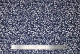 Flat swatch John Louden fabric (navy blue fabric with white leafy floral swoopy pattern allover)