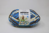 Ball of Bernat Baby Blanket in shade Little Royales (blue, taupe, white)