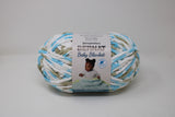 Ball of Bernat Baby Blanket in shade Little Teal Dove (white, taupe, blue)