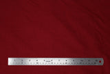 Flat swatch of cotton solid in scarlet (dark red)