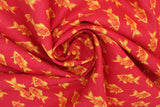 Swirled swatch fish print fabric in red (red coloured fabric with orange coloured alternating fish pattern lines)