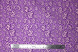 Flat swatch of peony printed fabric in purple (medium purple fabric with light purple cartoon peony heads tossed)