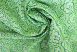 Swirled swatch of peony printed fabric in green (lime green fabric with light green cartoon peony heads tossed)