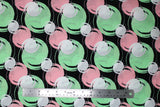 Flat swatch blotches printed fabric in black (black fabric with light pink, light green, and white coloured circular blotches collage)