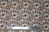 Flat swatch small stars and moons printed fabric in black (tan/beige fabric with tossed stars and moons allover in white, black, brown)
