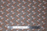 Flat swatch small leaves printed fabric in grey (grey fabric with tossed cartoon white/brown leaves and small occasional black polka dots)