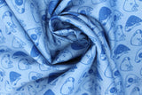 Swirled swatch of puppy heads printed fabric in blue (blue fabric with dark blue doodled puppy heads tossed)