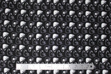 Flat swatch of puppy heads printed fabric in black (black fabric with white doodled puppy heads tossed)