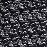 Square swatch of mountain cabins printed fabric in black (black fabric with tossed white cartoon mountains and cabin print repeated)