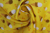 Swirled swatch food printed fabric in ice cream cones (yellow fabric with tossed vanilla, chocolate, and combined ice cream scoops in brown cones and tossed orange cherries)