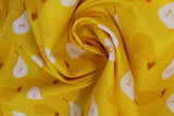 Swirled swatch food printed fabric in pears (yellow fabric with tossed yellow pears and half cut pears in white)