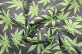 Swirled swatch of pot leaf print fabric on black