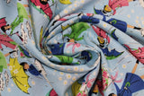 Swirled swatch mae flowers scene (girls with umbrellas) printed fabric in blue