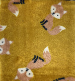 Swatch of two-sided fleece flannel in Fox (light brown foxes on gold)