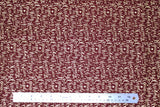 Flat swatch Oh Holy Night themed Christmas fabric in Gold Script on Red