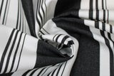 Swirled swatch onyx stripe fabric (white fabric with thick black stripes and groups of small black stripes within the white spaces)