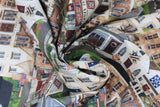 Swirled swatch stacked houses fabric (lines of stacked residential style houses with american flags and labels "General Store" "Town Hall" etc. with road and greenery in background)