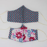 Front and back view of ninja style mask with off white elastic ear loops (grey and black small plaid with squares of pink and blue with white accents)