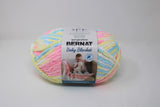 Ball of Bernat Baby Blanket in shade Pitter Patter (yellow, pink, blue, white)