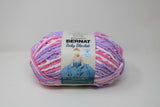 Ball of Bernat Baby Blanket in shade Pretty Girl (pink, purple, white)