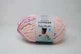 Ball of Bernat Baby Blanket in shade Raspberry Kisses (pink, peach)