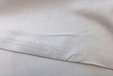 Raw hem swatch tiny florals fabric in blossom (white on neutral)