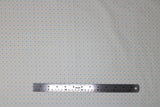 Flat swatch circles & dots print fabric in lily (tiny coloured dots on white)