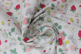 Swirled swatch berries fabric (white fabric with small tossed pink and red strawberries and generic berry shapes, tossed white and yellow floral, tossed greenery and outlines)