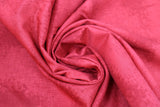 Swirled swatch near solid print fabric in red