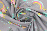 Swirled swatch grey fabric (grey fabric with small tossed emblems allover rainbows with floral/greenery, small teal and yellow snails with pink flower petals, teal coloured rocks, tiny teal and yellow dots and stars)