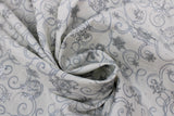 Swirled swatch Silver fabric (white fabric with tossed grey snowflakes allover with lots of grey swirl shapes and silver metallic/sparkle accents)