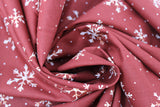 Swirled swatch winter printed fabric in White Snowflakes on Orange