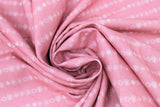 Swirled swatch flowers fabric (light pink fabric with small white lines of floral head stripes outlined)
