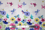 Flat swatch World of Susybee printed fabric in Grassy Runner (colourful cartoon flowers)