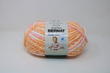 Ball of Bernat Baby Blanket in shade Sweetie Coral (pink, peach, ivory)